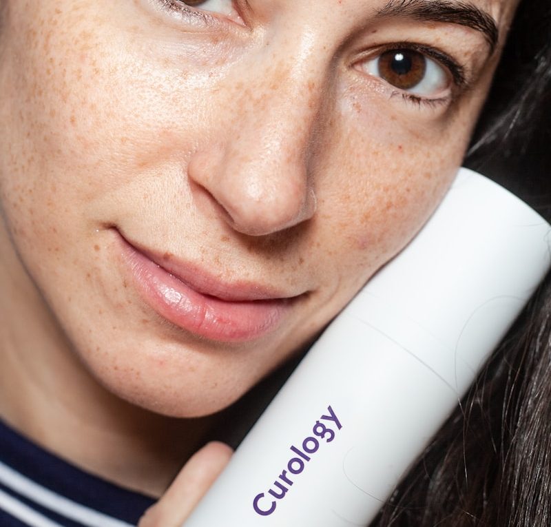 woman holding Curology bottle
